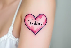A soft pink heart outlined in black, cradling the name Tobias in cursive. tattoo idea