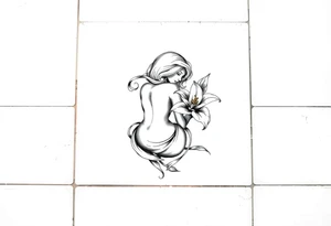 A simple tile floor. On top of the tile A curled figure with a lily next to her tattoo idea