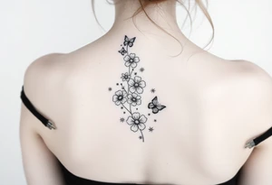 Flowers down the spine surrounded by small butterflies and sparkles tattoo idea