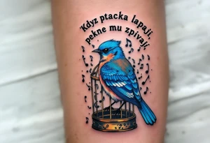 "Kdyz ptacka lapaji, pekne mu zpivaji." — A bluebird in a gilded cage made of musical notes, with the proverb arched in fine black ink above. tattoo idea