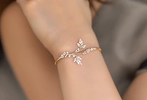 A thin, delicate gold ring with intricate white filigree engravings, symbolizing timeless elegance and devotion. tattoo idea