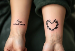 "Amor Vincit Omnia" (Love conquers all) in soft cursive lettering, placed inside a delicate heart made of olive branches, inked in charcoal black with touches of olive green. tattoo idea