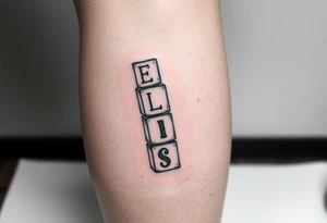 childrens blocks with ELISE on them vertically arranged on the calf tattoo idea