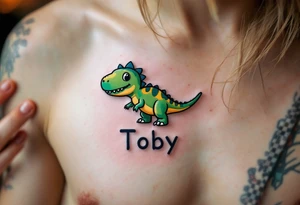 A tiny dinosaur in green and grey, with the son’s nickname Toby written in playful bold font beneath. tattoo idea