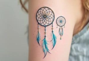 Three delicate dreamcatchers, each woven in a different hue—turquoise, gold, and silver—with small charms representing each person. tattoo idea