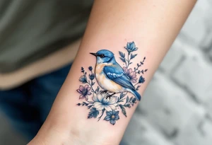 Puffy bluebird surrounded by wild flowers tattoo idea