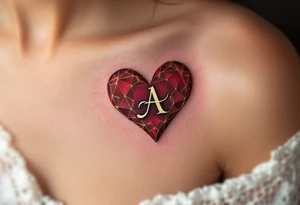 A deep red heart with a golden cursive letter "A" delicately engraved in the center, symbolizing passion and devotion. tattoo idea