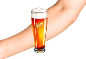 A tall, ice-cold pilsner glass with a thick white foam head, illuminated by warm amber and honey hues tattoo idea