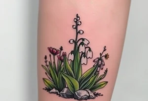 Small White lily in the valley bells growing next to other different colored lilie plants planted 
around  blooming hawthorn tree tattoo idea