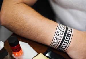 tattoo on wrist that says "resurget cineribus" in a latin bold font tattoo idea