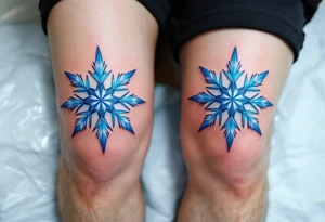 Icy blue eight-point stars with light gray accents, centered on each kneecap, resembling frost or snowflakes with a crisp, cold feeling. tattoo idea