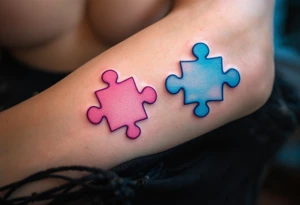 Interlocking puzzle pieces in soft pink and muted blue on the inner wrists symbolize how perfectly you fit together. tattoo idea