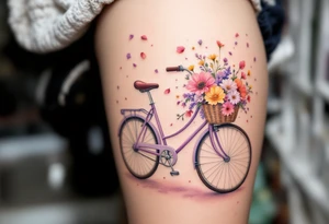 A bike with a basket full of wildflowers, colored in soft purples, pinks, and yellows, with petals floating into the air for a whimsical, carefree feel. tattoo idea