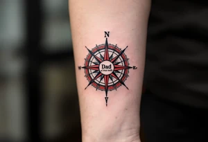 A traditional-style compass with red and black detailing, pointing toward “Dad” at true north. tattoo idea