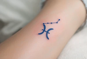 A bold constellation in sapphire ink arcs over a pale Pisces glyph, creating a celestial connection on the wrist. tattoo idea