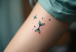 In this tattoo, a gradient of sea-green and teal forms the Pisces stars with the zodiac glyph in matching hues. tattoo idea