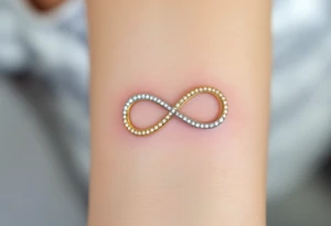 An infinity symbol made of two interlocking wedding bands, shaded in gold and platinum, with tiny diamond sparkles. tattoo idea