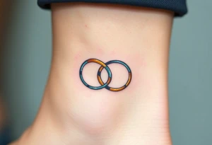 A delicate infinity symbol made of interlocking wedding rings, with soft metallic gold and silver tones tattoo idea