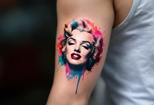 Watercolor Marilyn Monroe tattoo with splashes of red, pink, and blue around a classic black-lined face. tattoo idea
