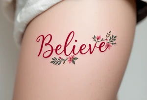 "Believe" in vibrant red with floral accents in soft pink and green, representing growth and perseverance. tattoo idea