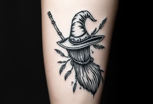 Which is broom with a witches hat with vines and feathers on your leg tattoo idea