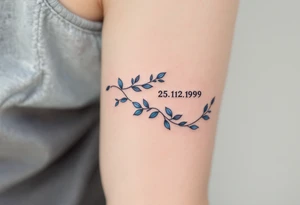 Cursive 25.12.1999 flowing along the spine in cool gray with a hint of icy blue. tattoo idea
