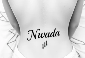 a woman's waist with the word "Nwada" written on her waist make her sit on the bed tattoo idea
