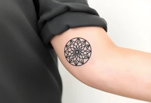 A minimalist black ink Flower of Life, centered on the forearm, with perfect geometric symmetry in cyrcle round tattoo idea