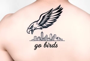 Philadelphia Eagle classic logo flying over Philadelphia city skyline with the words go Birds under it on bicep tattoo idea