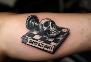 A chessboard with a fallen black king piece shaped like a skull, with "memento mori" in elegant black Gothic lettering across the board’s edge. tattoo idea