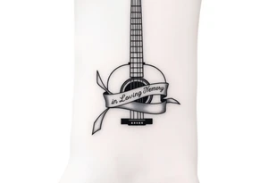 Accustic Guitar with ribbon wrapped around with In Loving Memory inside ribbon tattoo idea