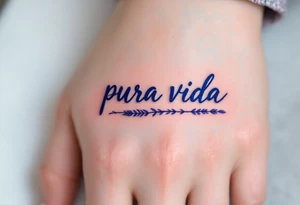 Simple cursive “Pura Vida” inked in navy blue with a small lavender sprig underlining the text. tattoo idea