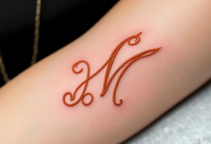 A stitched "M" design in warm beige and thread-red, resembling embroidery. tattoo idea