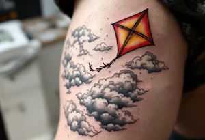 A red and gold kite soaring high over clouds, capturing childlike freedom and joy. tattoo idea