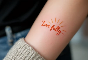 “Live fully” in bright coral ink, with yellow sun rays stretching outward. tattoo idea
