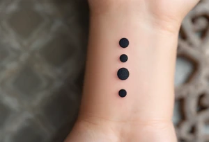 Three charcoal black dots forming a vertical ellipsis. tattoo idea