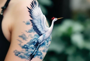 A white crane with black wing tips and red crown flying through misty blue clouds. tattoo idea