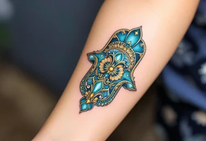 A vibrant turquoise and gold Hamsa with delicate filigree, radiating a mystical and regal aura. tattoo idea