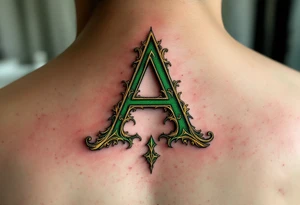 A calligraphy "A" in emerald green with fine golden flourishes. tattoo idea
