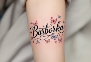 Barborka name wrapped in a flowing ribbon, with soft pastel butterflies fluttering around. tattoo idea