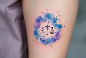 Soft watercolor shades of blue and lavender cradle the Libra star constellation pattern beneath a minimalist zodiac symbol tattoo idea