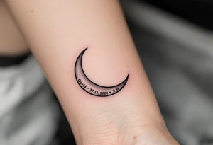 Crescent moon with "David – 27.11.2020 v 3:33" nestled in its curve, done in silver-gray and black. tattoo idea