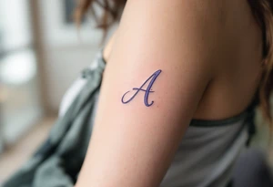 A delicate cursive "A" in soft lavender ink with a watercolor wash. tattoo idea