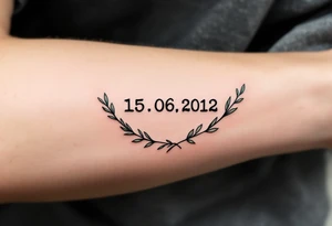15.06.2012 in typewriter font encased in a dusty green laurel wreath. tattoo idea