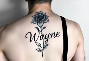 flower with a stem turning into the name wayne in cursive on rib cage tattoo idea