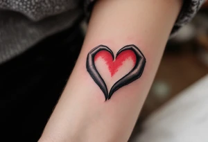 Two half-heart tattoos in black with red tips that form a full heart when partners shoulders are side by side tattoo idea