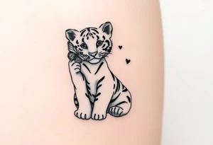 Tiger cub sitting down with paw up and on the paw is sitting a butterfly and there’s two butterflies on each side tattoo idea