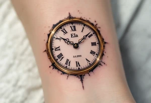 Delicate golden clock hands frozen at 9:17, with "Ela" and 3.5.2022 in fine black ink. tattoo idea
