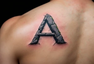 A cracked stone "A" in granite gray with mossy green details. tattoo idea