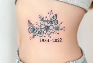flowers and butterflies with the name “NANA” and the date “1954-2022” mixed all together on the side of the rib cage tattoo idea